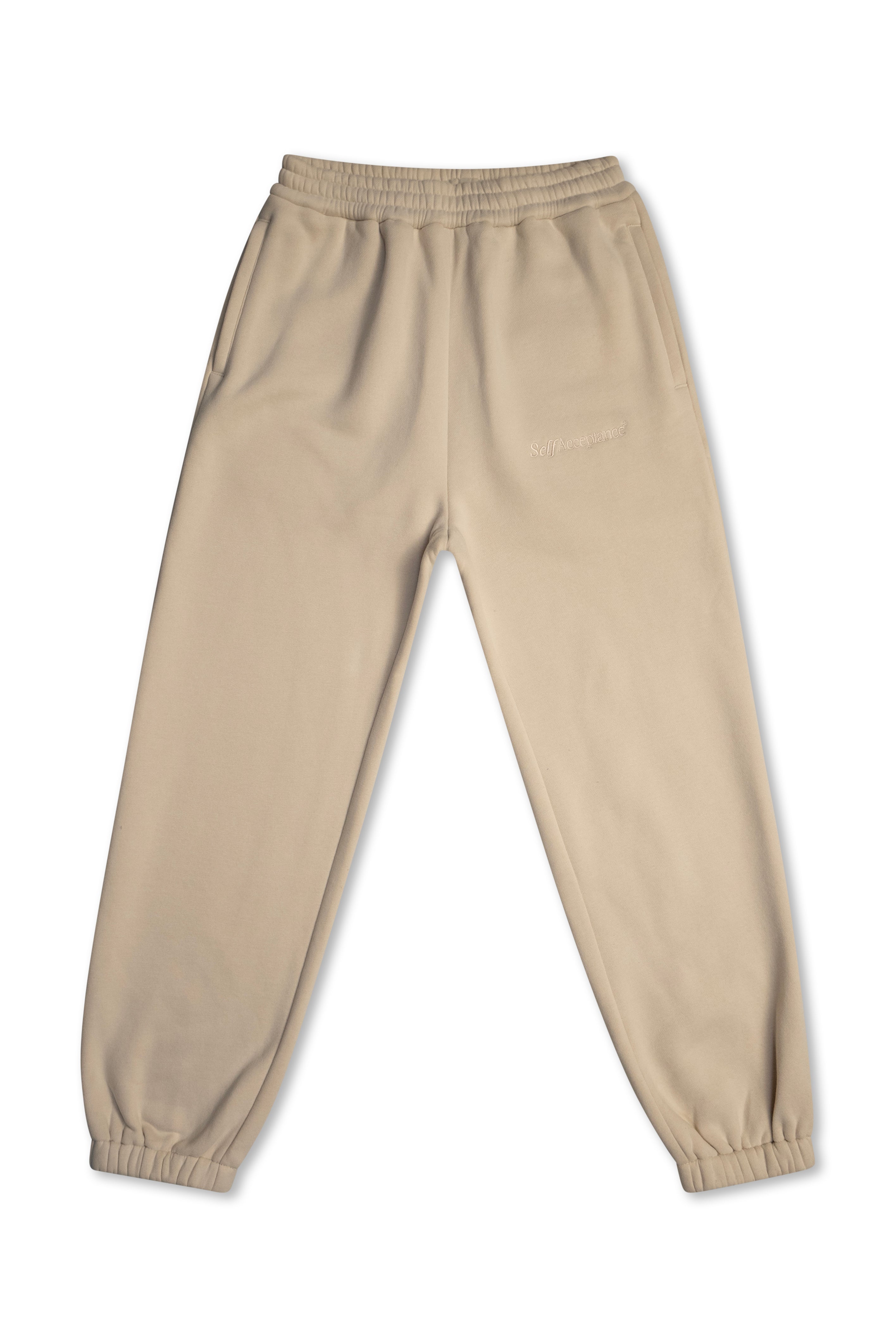 A pair of beige jogger sweatpants with an elastic waistband and elastic cuffs, laid flat against a white background.