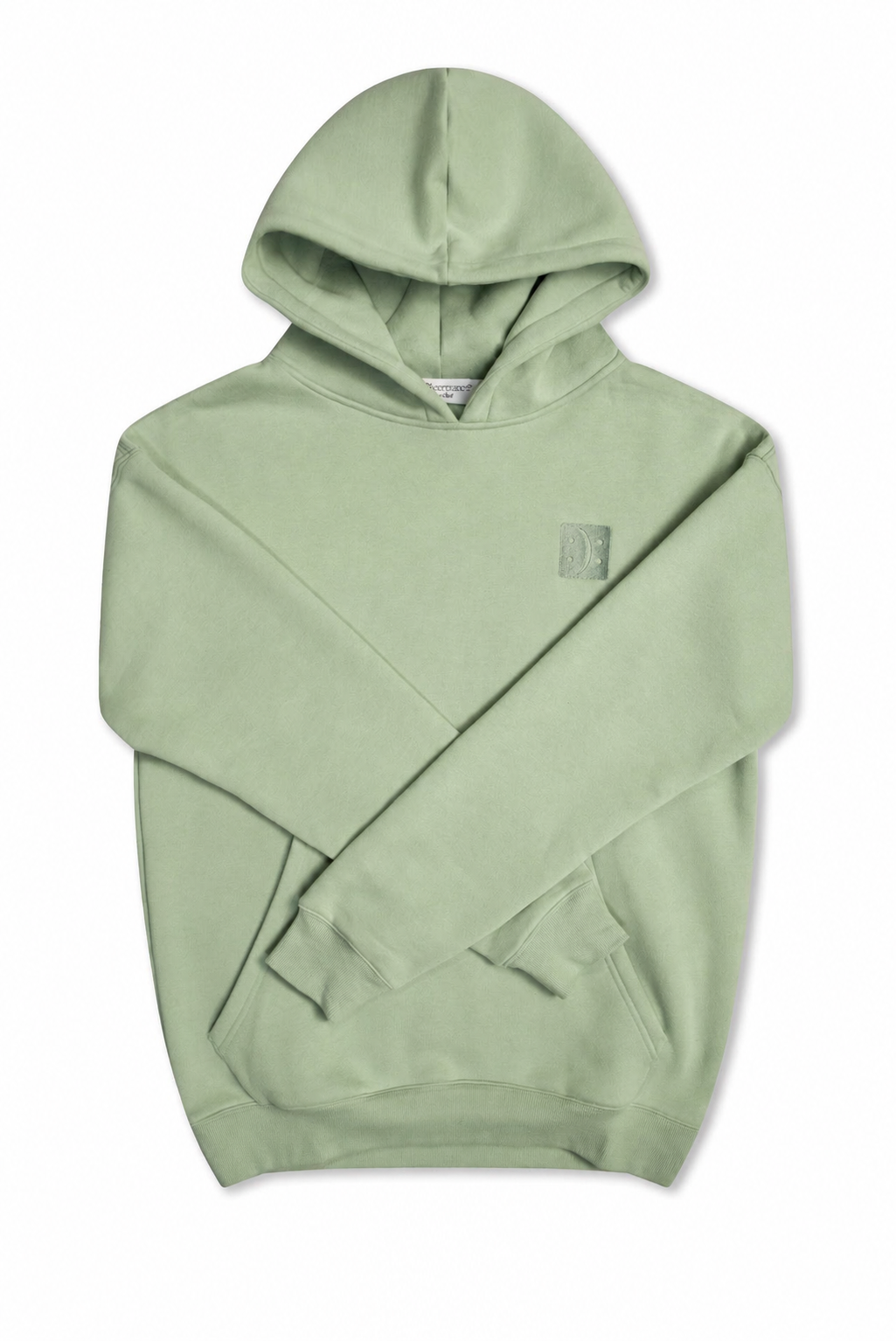 Front view of a match green heavyweight hoodie featuring a small embroidered Self Acceptance icon on the left chest.

#color_matcha