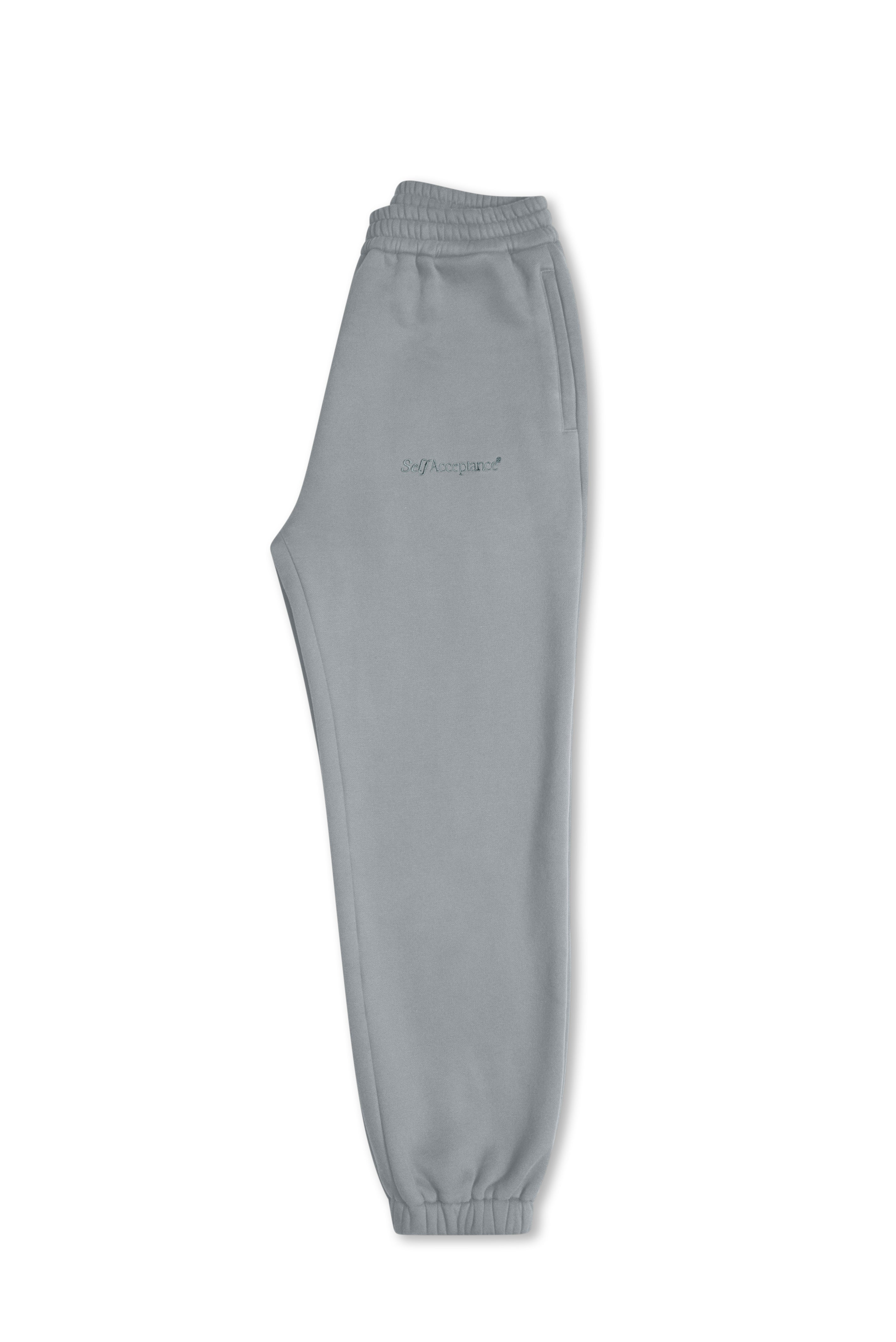 Light gray blue sweatpants with an elastic waistband and cuffs, featuring a small embroidered logo on the left thigh, shown against a plain white background.
