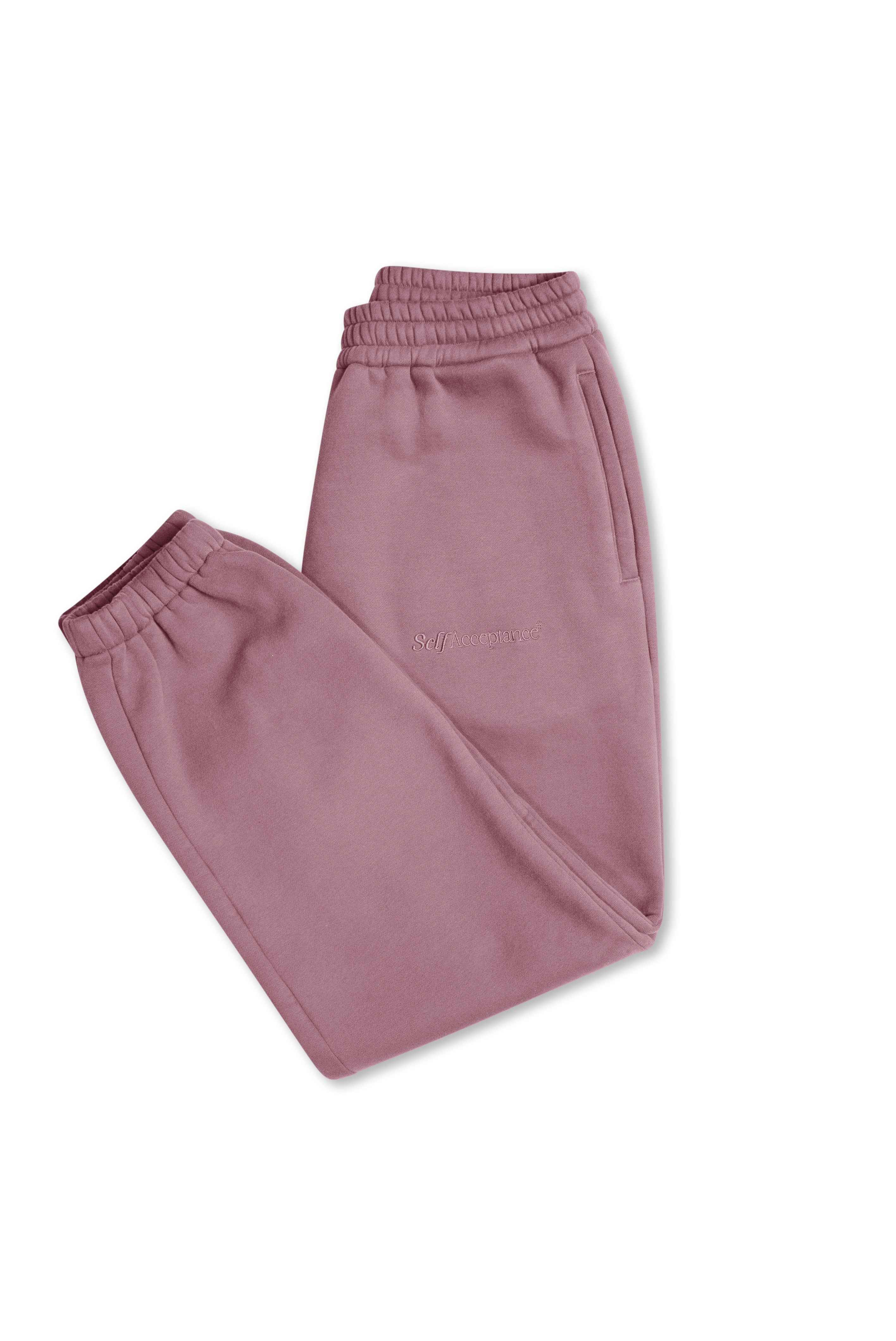 A pair of dusty rose fleece jogger pants with elastic waistbands and cuffs, laid flat on a white background.