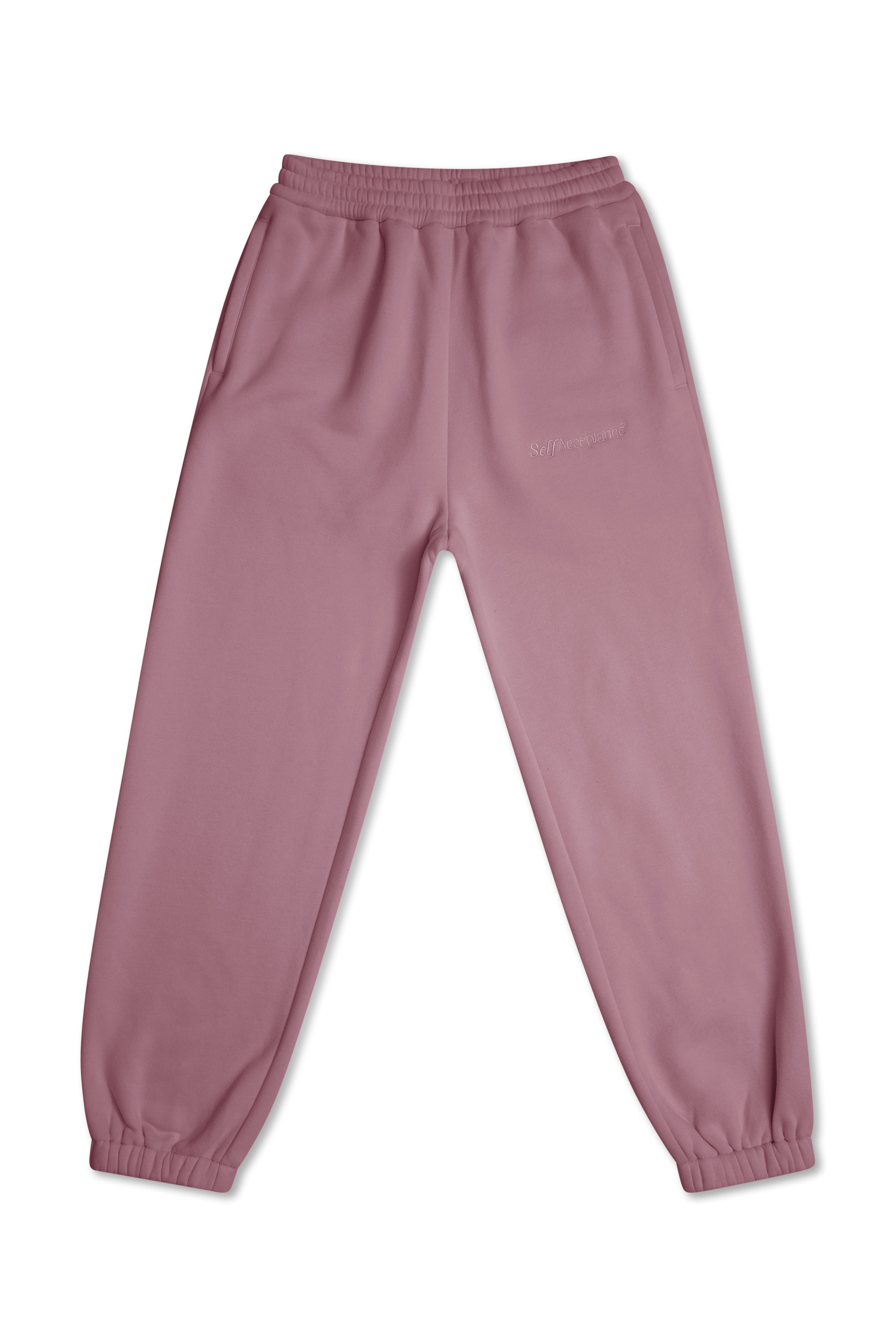 A pair of dusty rose pink sweatpants with an elastic waistband and cuffed ankles, laid flat against a white background.