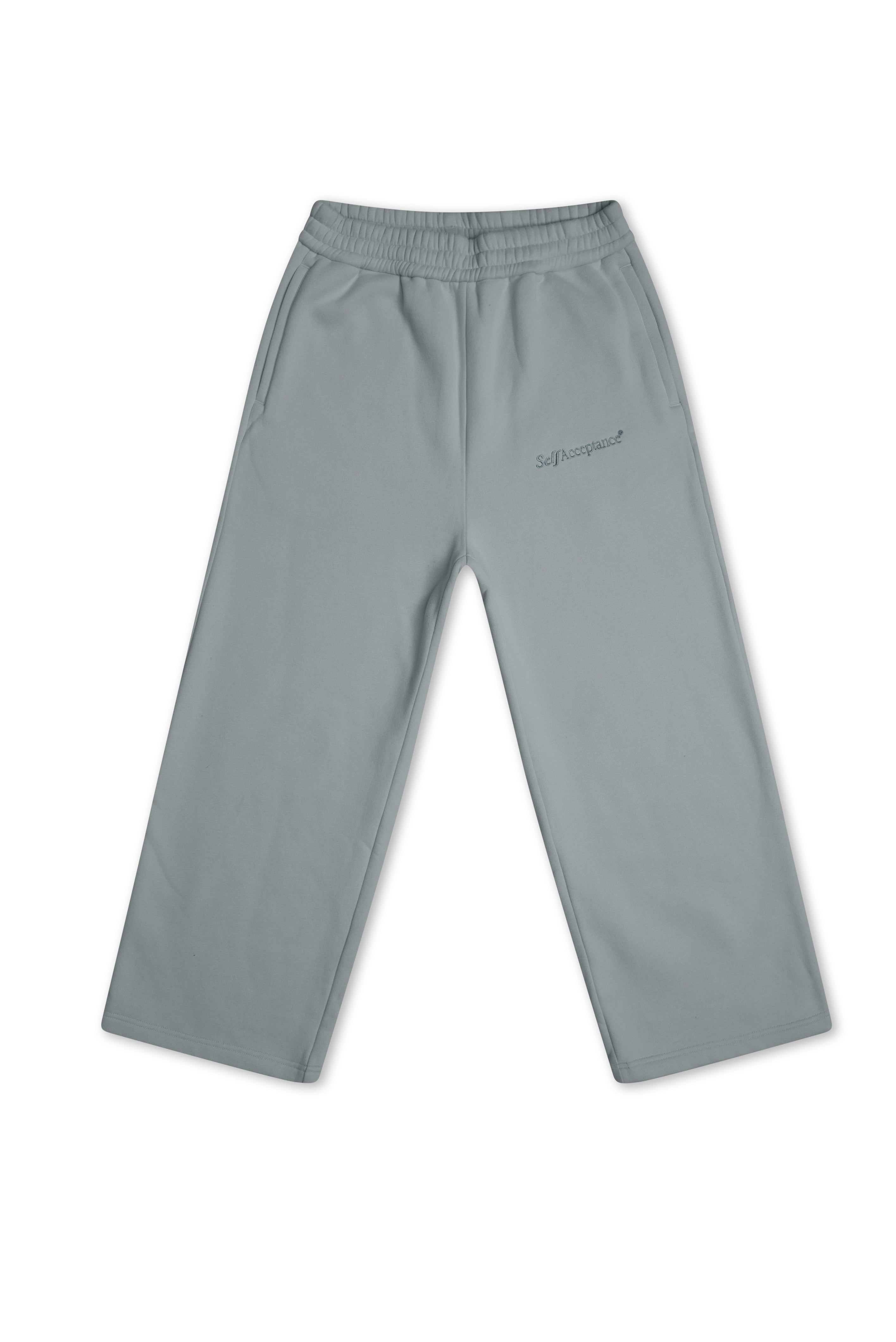 A pair of light gray blue sweatpants with an elastic waistband and a small dark gray embroidered logo on the left thigh, displayed flat against a white background.