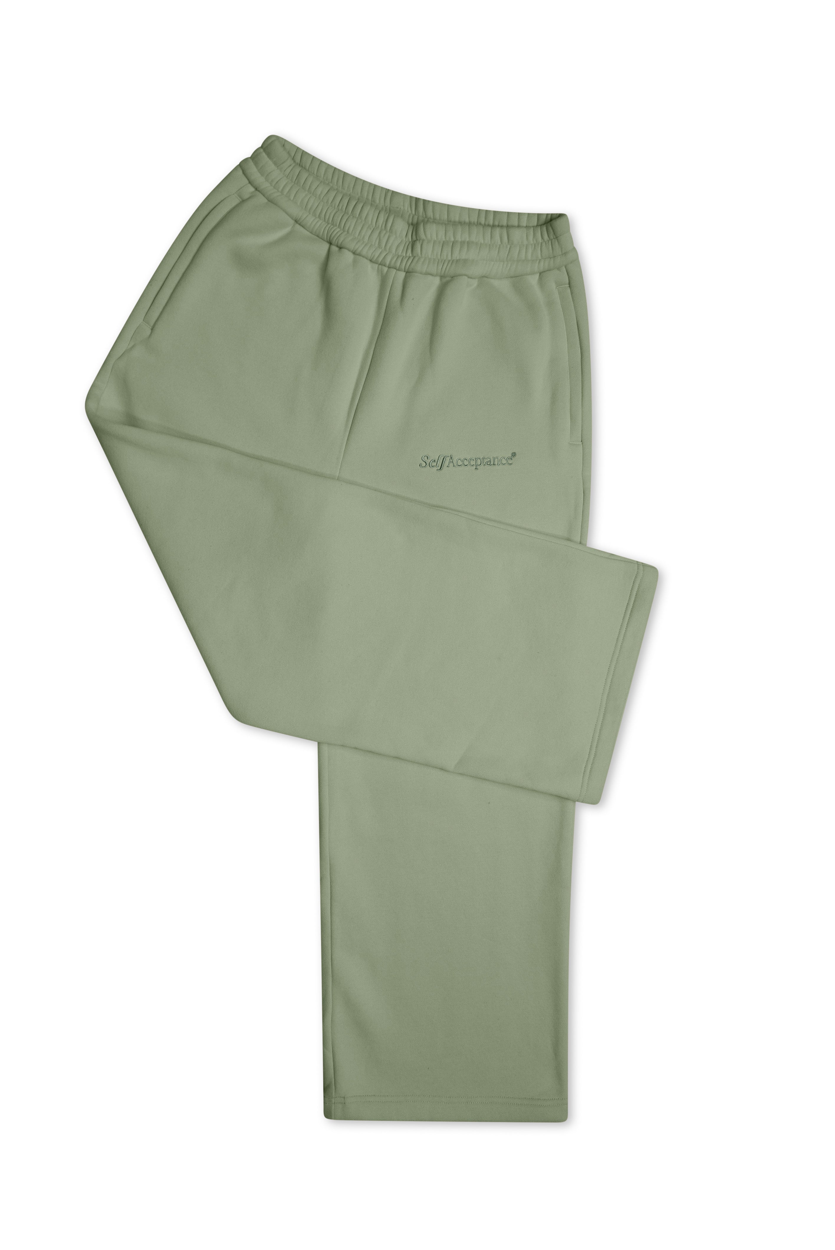 A pair of sage green athletic pants with an elastic waistband and a small script logo on the left thigh, displayed against a plain white background.