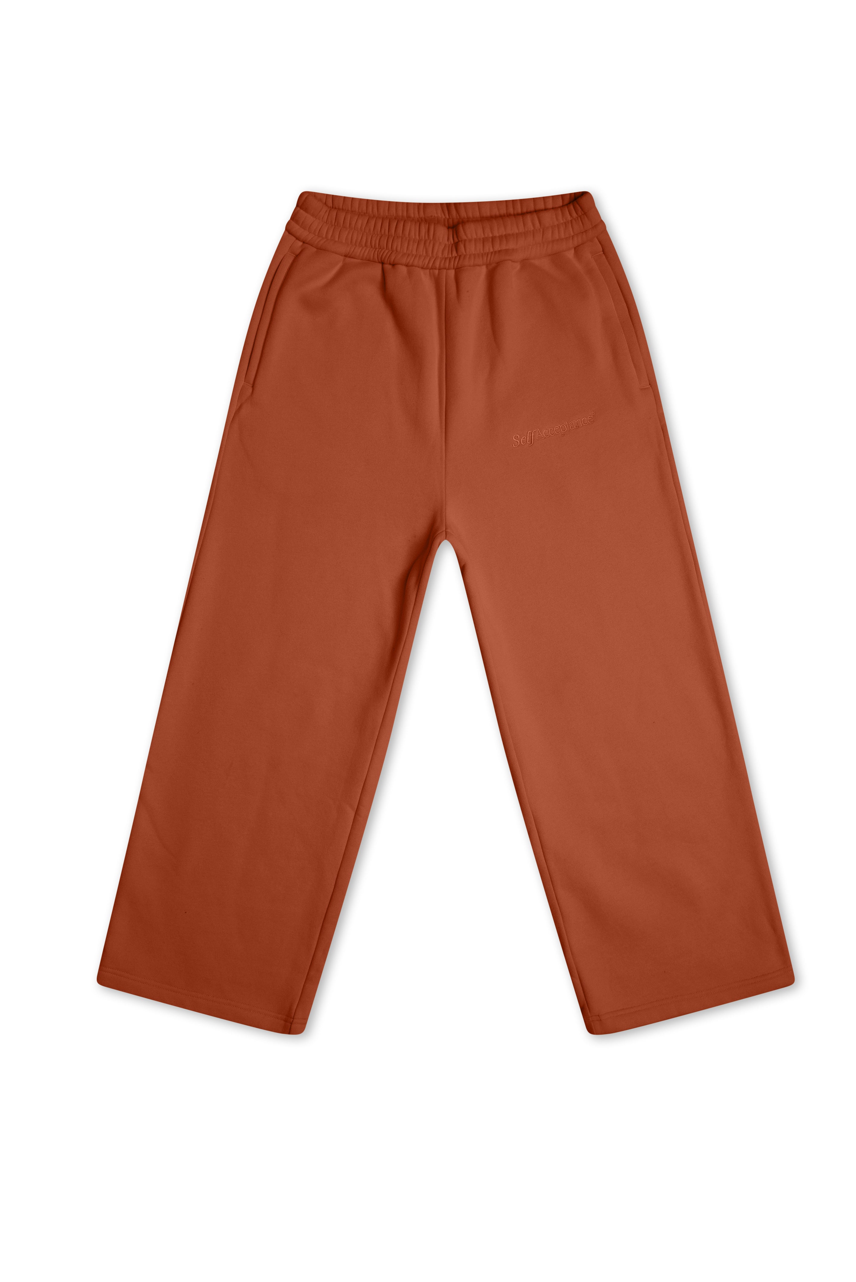 A pair of rust-colored wide-leg pants with an elastic waistband, shown flat against a plain white background.